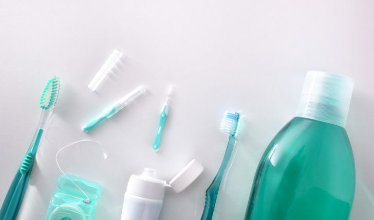 Equipment for oral hygiene on a white table. Horizontal composition. Top view.